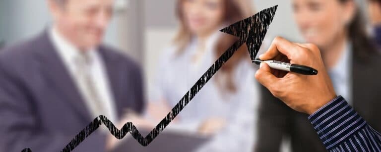 A man drawing an upward arrow with a permanent marker
