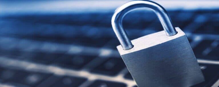 Data Security Encryption Photo Concept with Metallic Padlock on Laptop Computer Keyboard.