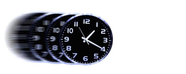 Detail of clock face with numbers and hands showing time