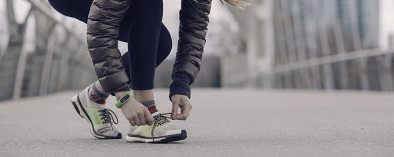 A female runner tying her shoelaces